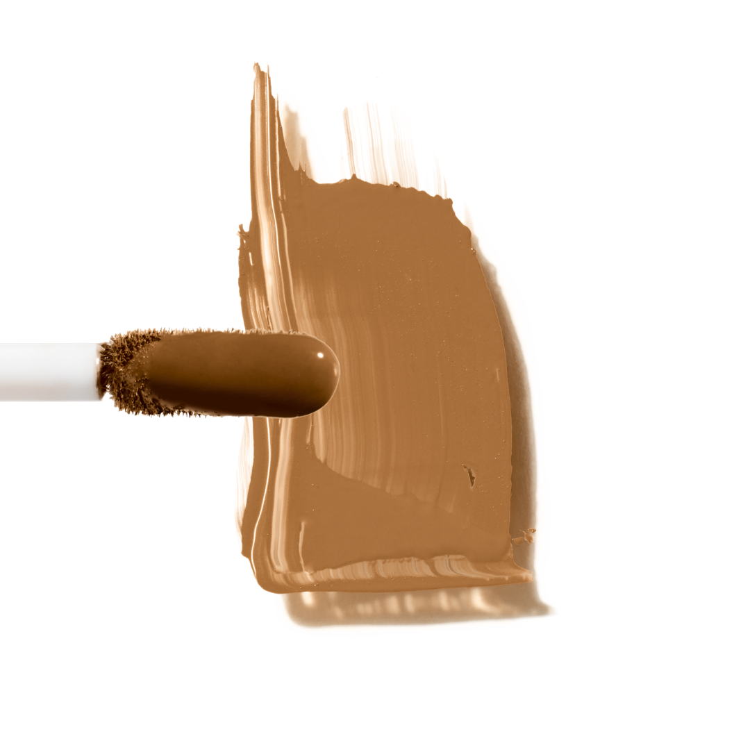 Maxine's Revenge French Face concealer shade Deep Tan tube on a white background; blurring hydrating, stretchy foundation concealer for a natural radiant beautiful complexion