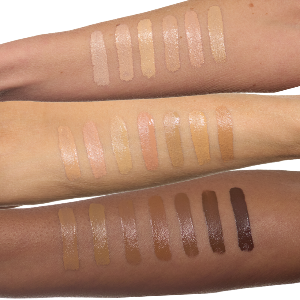 Makeup swatches on arms showing a range of neutral tones.