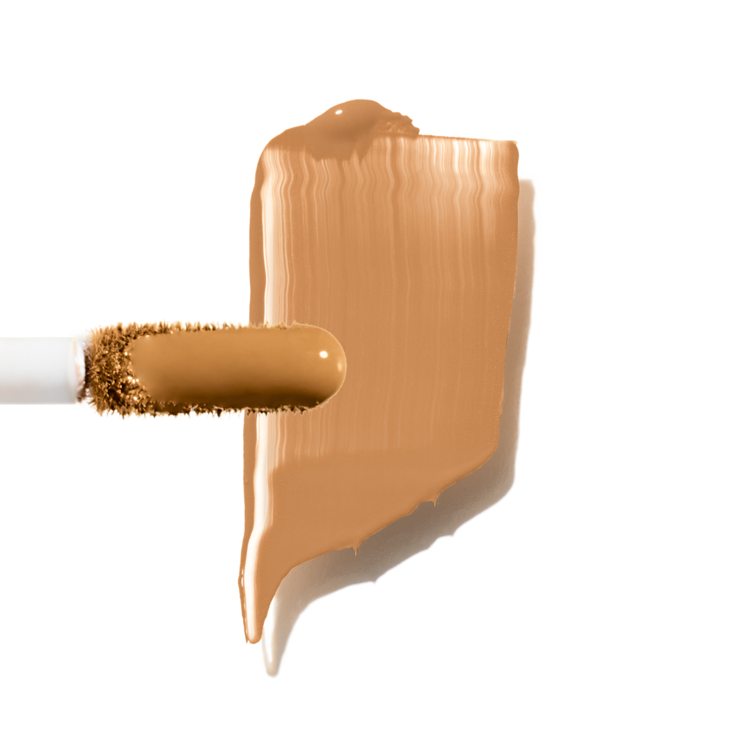 Maxine's Revenge French Face concealer shade Medium Deep Tan tube on a white background; blurring hydrating, stretchy foundation concealer for a natural radiant beautiful complexion