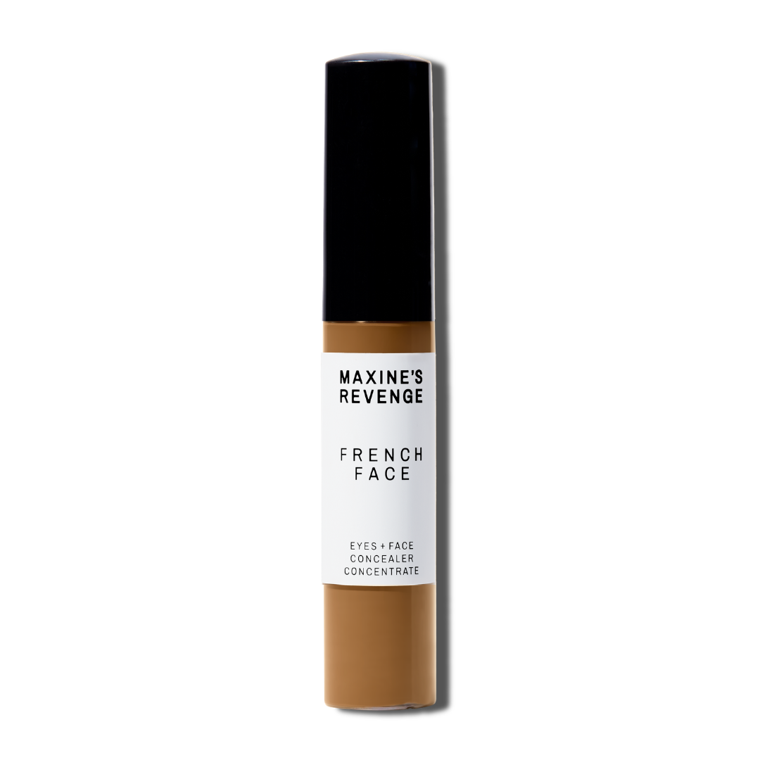 Maxine's Revenge French Face concealer shade Deep Tan tube on a white background; blurring hydrating, stretchy foundation concealer for a natural radiant beautiful complexion